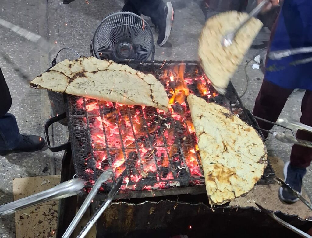 preparation of tlayuda street food in Oaxaca